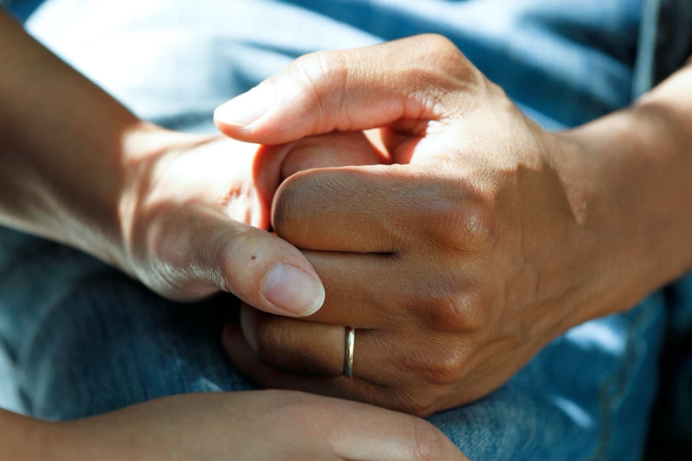 Close-up of two people holding hands